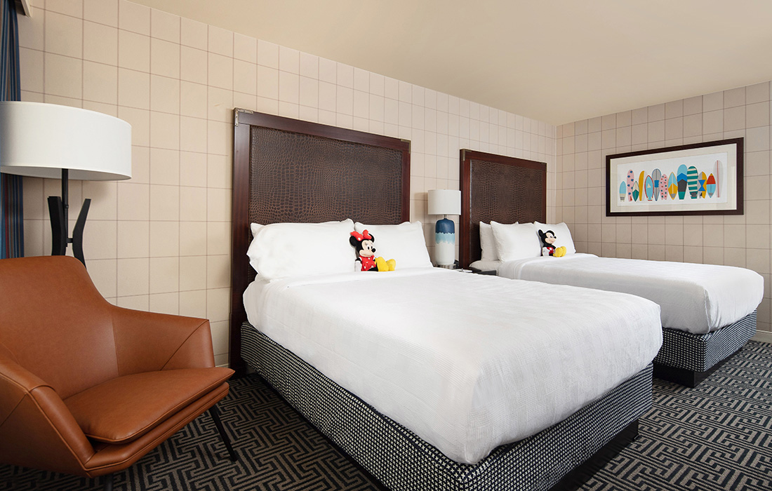 Our double queen hotel rooms in Anaheim feature family friendly decor and two plush queen beds.